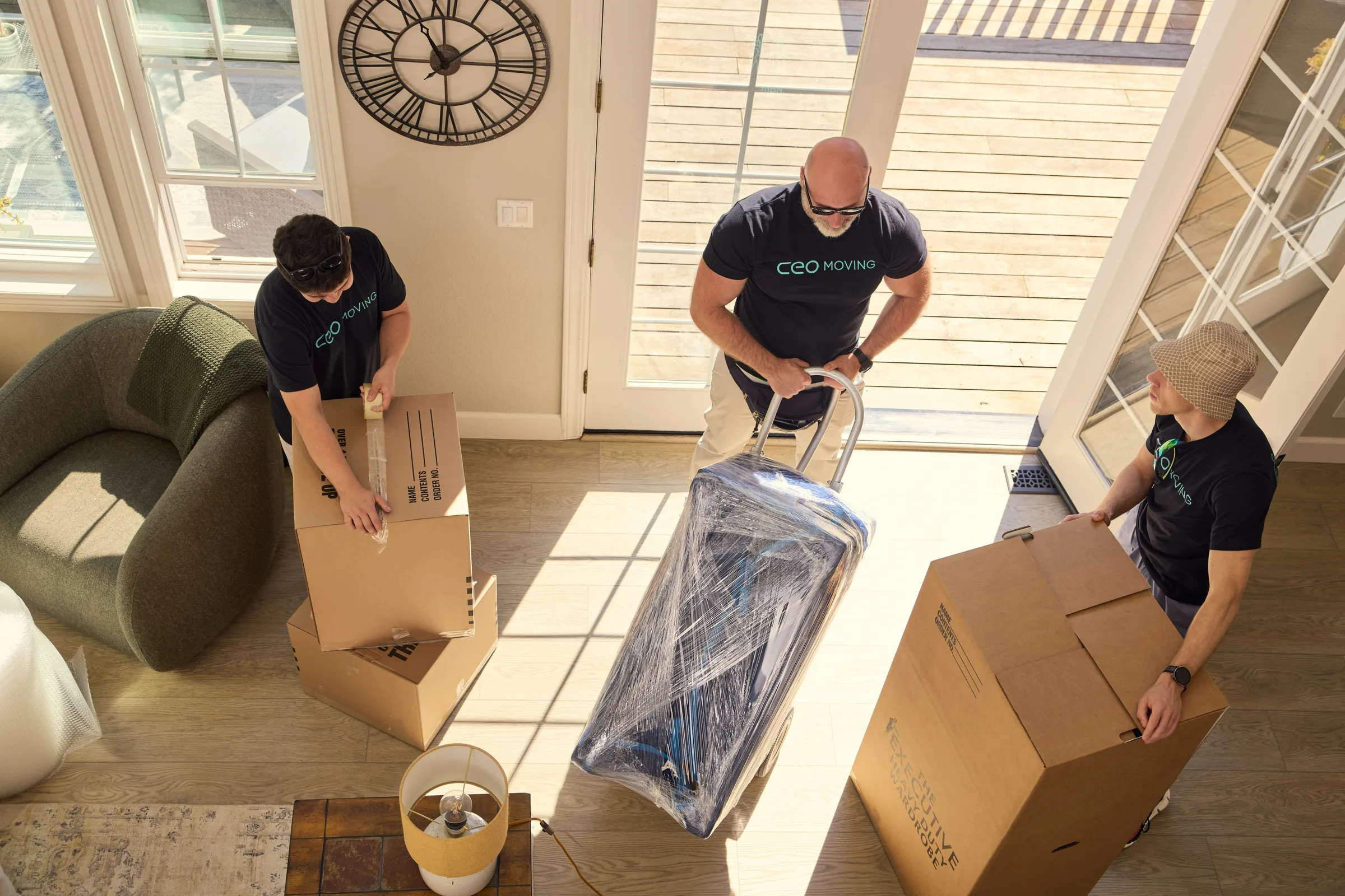 Long distance moving company crew packing boxes and loading furniture during a cross country move