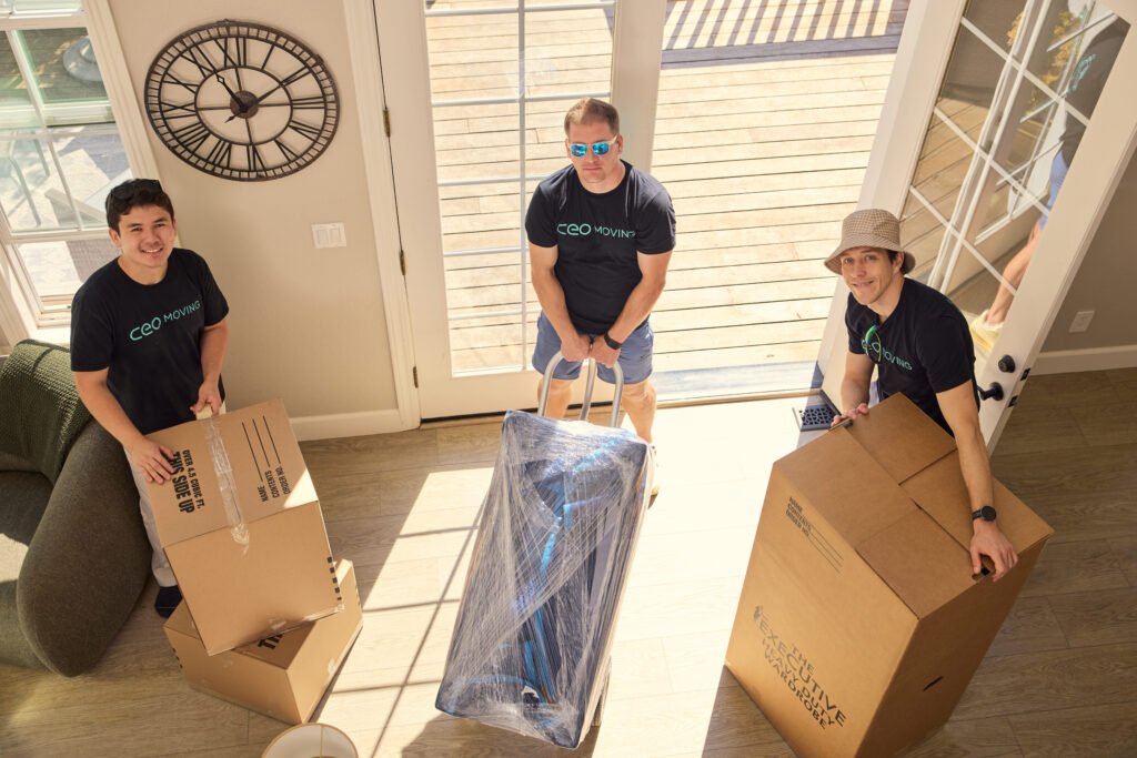 Packed boxes and wrapped furniture staged inside a home before local movers arrive