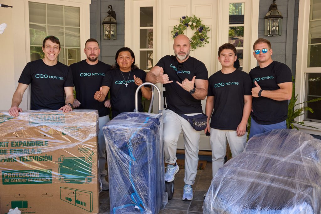 CEO Moving crew with boxes and wrapped furniture outside a Bay Area home on moving day
