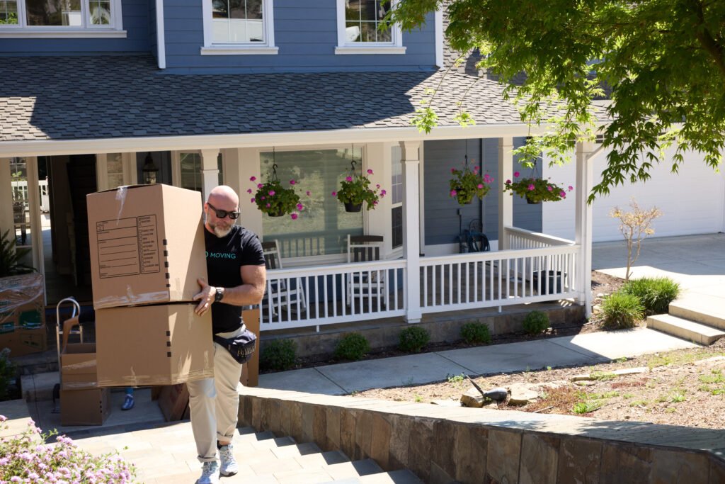 Movers carrying boxes into a family home in one of the best places to live in the Bay Area