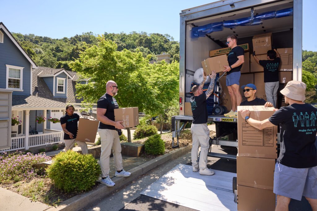 CEO Moving crew loading boxes into their own branded moving truck