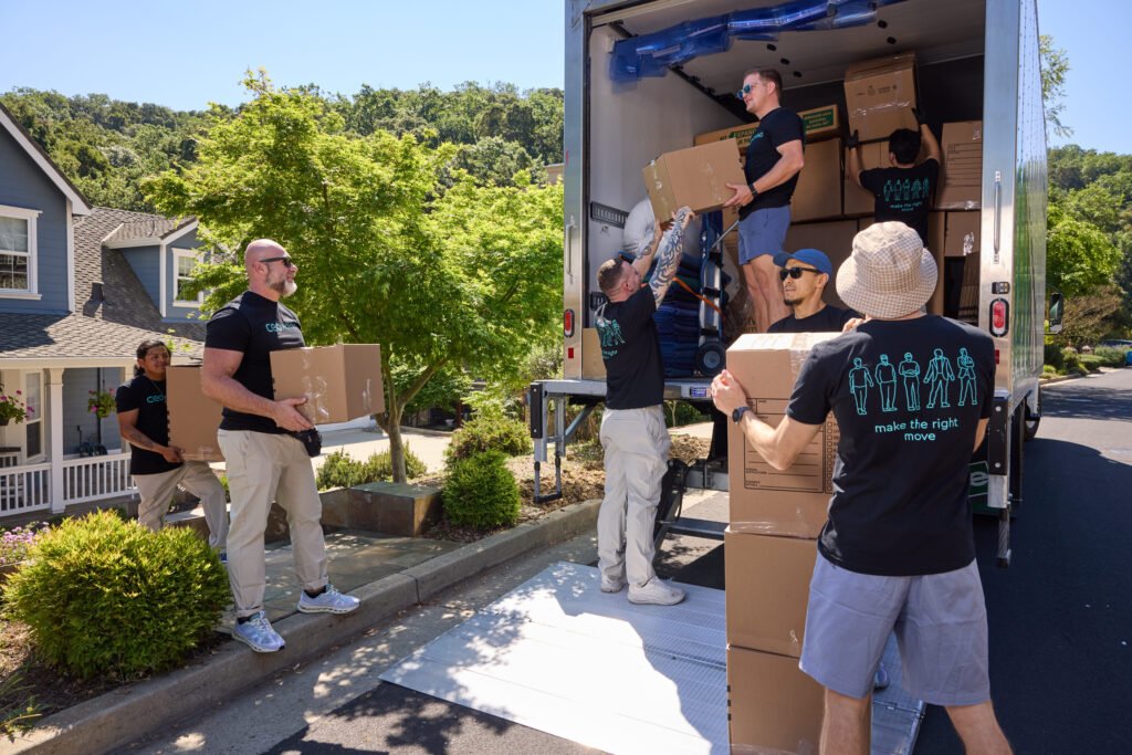 CEO Moving crew showing how to pack a moving truck with boxes stacked in tight tiers