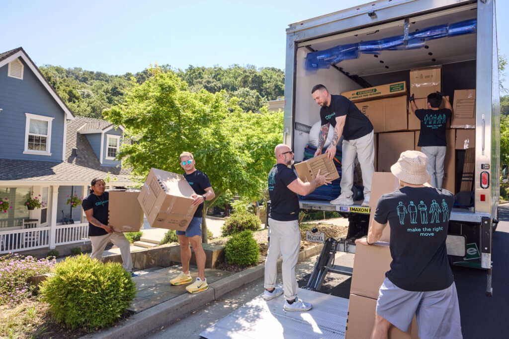 Movers loading boxes into a truck on a local moving day