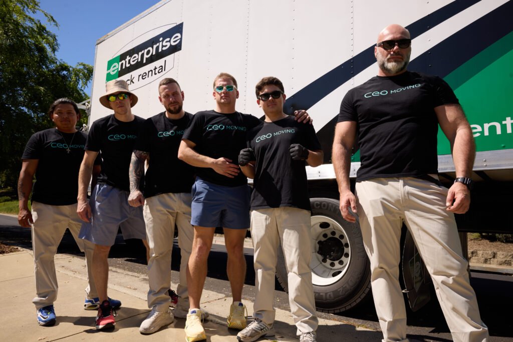 CEO Moving commercial moving crew standing in front of their trucks