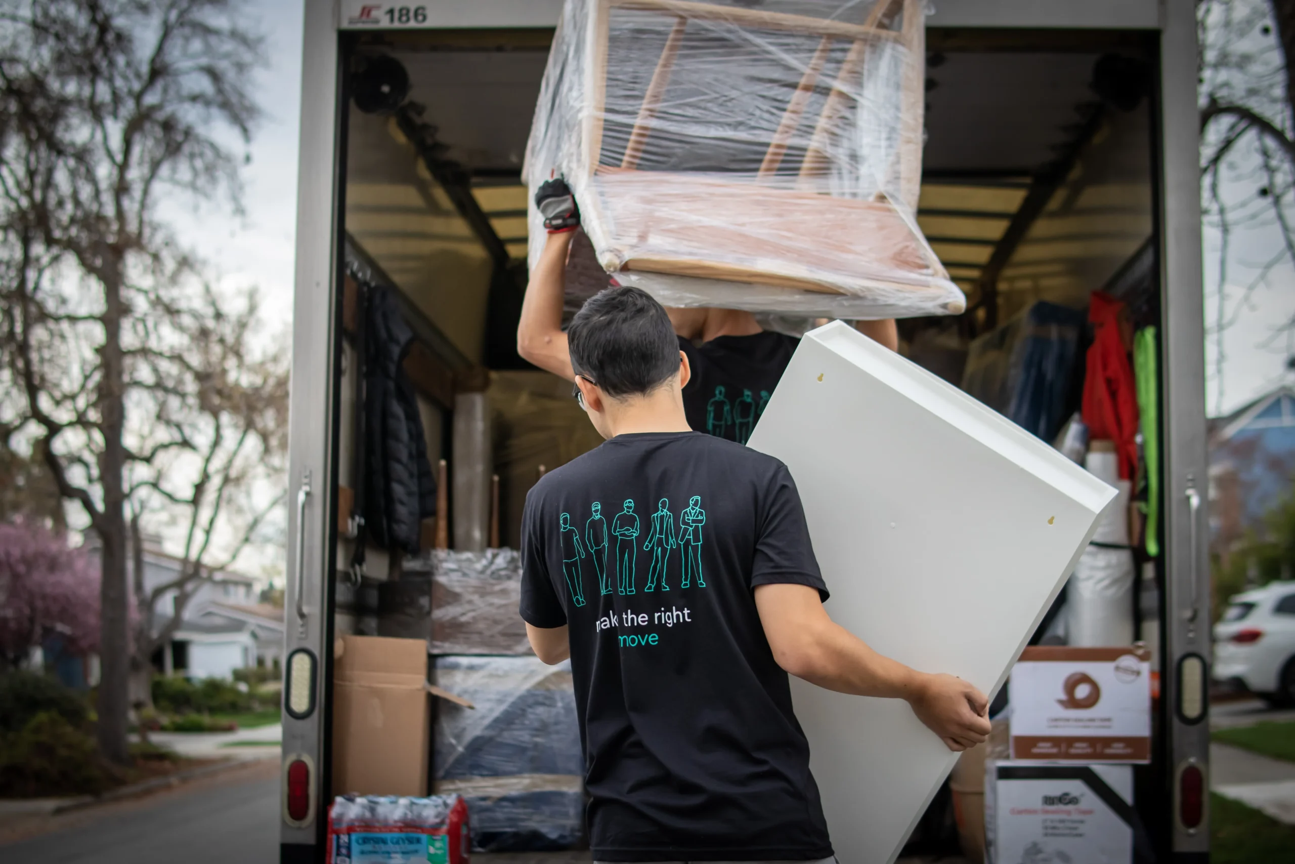 Professional movers loading furniture into a moving truck during a Bay Area home move — change of address checklist