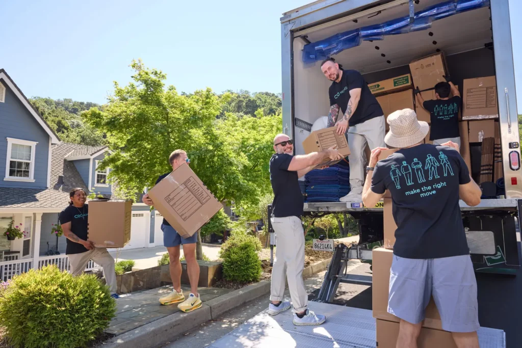 Professional movers from CEO Moving loading boxes and furniture into a moving truck outside a client's home