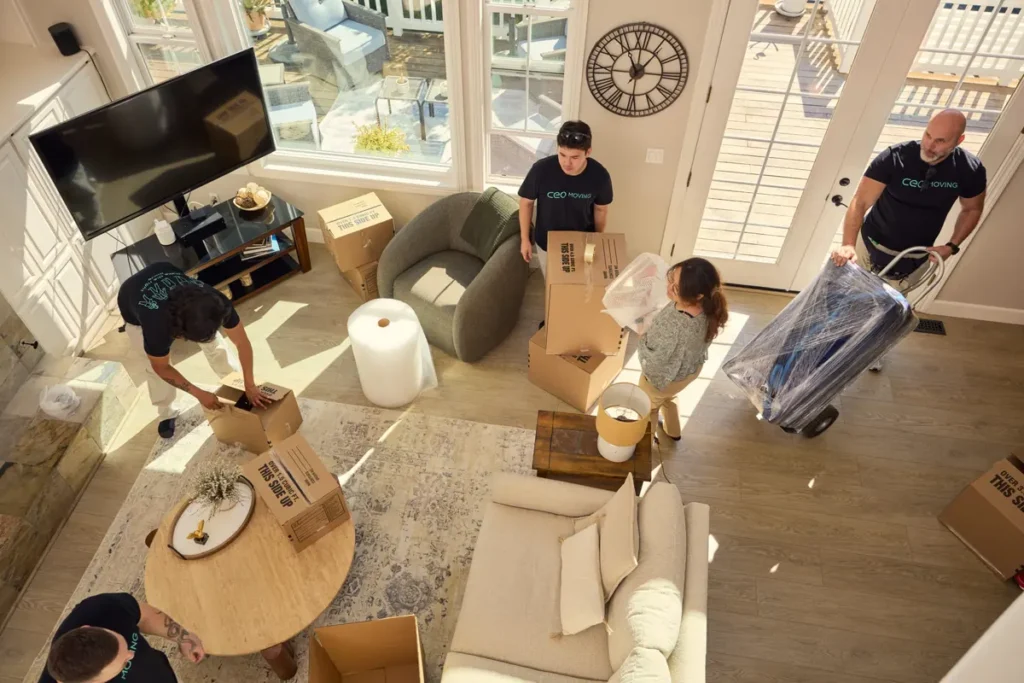 CEO Moving crew packing boxes and wrapping furniture for a last-minute move in a Bay Area home