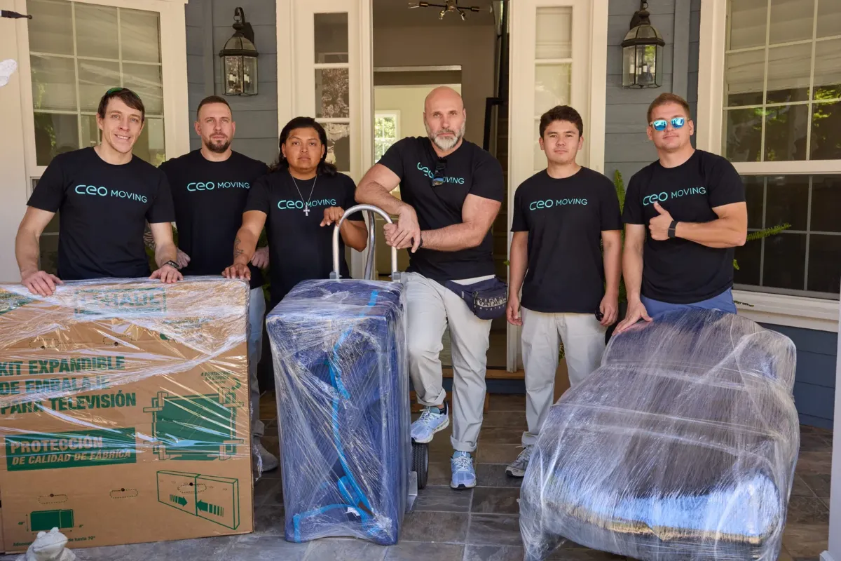 CEO Moving crew in branded uniforms standing with wrapped furniture, a licensed Bay Area mover you can verify to avoid moving scams